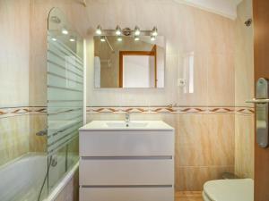 a bathroom with a sink and a shower and a mirror at Ribes Duplex by Hello Homes Sitges in Sitges +24 photos