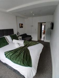 a bedroom with a large bed and a living room at Flat 5 - Eign St Hereford in Hereford