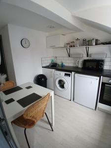 a small kitchen with a table and a microwave at Flat 5 - Eign St Hereford in Hereford