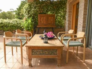 a wooden table and chairs on a patio at Alegre Playa Grupo Terra De Mar in Calpe
