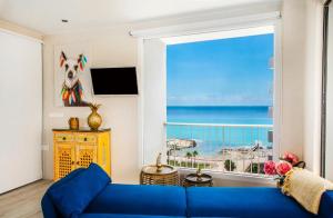 a living room with a blue couch in front of a window at Playa Salinas Grupo Terra De Mar in Calpe