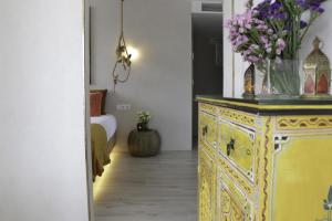 a yellow dresser with flowers on it in a room at Playa Salinas Grupo Terra De Mar in Calpe