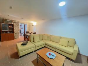 a living room with a couch and a table at Palheiro do Farrobo in Porto Moniz