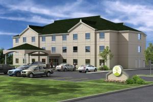 a rendering of a building with cars parked in a parking lot at Poplar Tree Inn in Stoughton