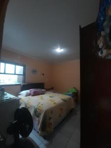 a bedroom with a bed in a room with a window at Pousada Ana in São Gabriel
