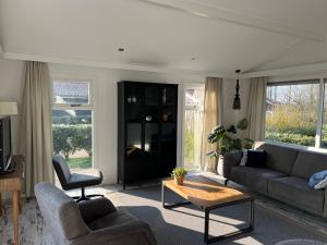 a living room with a couch and a table at Diek42 in Kattendijke