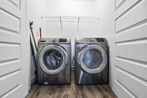 two washing machines in a laundry room with white cabinets at Garage w/ Veranda & Washer + Dryer in Atlanta