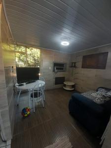 a room with a bed and a table in a room at Pousada Ana in São Gabriel