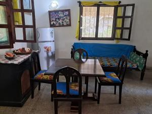 a living room with a table and chairs and a couch at Karibuni in Malindi