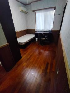a small room with a bed and a desk and a window at Kanupata - Vacation STAY 18614 in Ishigaki Island