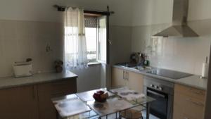 a kitchen with a table and a window in it at Casa da Calçada - Piso 1 in Seia