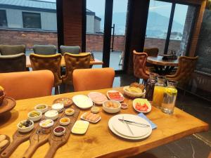 a wooden table with food on it in a restaurant at Tsalamuri Old Tbilisi in Tbilisi City