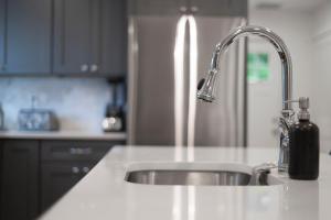 a kitchen sink with a faucet and a counter top at Family Friendly 3BD Oasis-Parking, WIFI & Pets OK! in Salem +17 photos