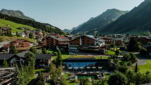a town in a valley with mountains in the background at Hotel Austria Lech in Lech am Arlberg