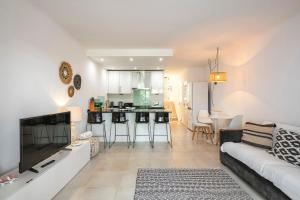 a living room with a couch and a kitchen at Villa V2 VALE DO LOBO BEACH & GOLF in Vale do Lobo