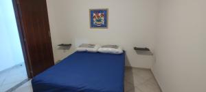 Ένα ή περισσότερα κρεβάτια σε δωμάτιο στο Anfitrioca Maricá Vista para o mar