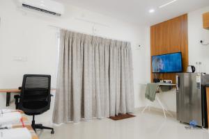 a room with a desk and a chair and a window at Bigson Blissful Studios in Hyderabad