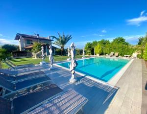 a swimming pool in a yard with a house at Villa Poggio Bardolino in Bardolino