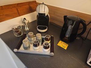a counter top with a coffee maker and a blender at Les chambres de Luciole in Asnières-lès-Dijon