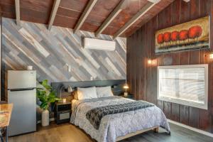 a bedroom with a bed and a wooden wall at Private Deck & Views: Frazier Mountain Cabin in Frazier Park