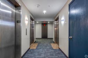a corridor of a hallway with doors and a hallwayngth at 1 - Serenity Suite - 1 - Reese Tower in Tulsa