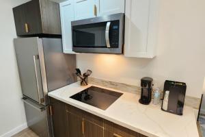a kitchen with a microwave and a refrigerator at 1 - Serenity Suite - 1 - Reese Tower in Tulsa +7 photos
