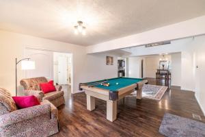 a living room with a pool table in it at The Affordable Family Fun House- Ping Pong, Pool Table, Darts in Post Falls