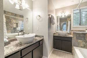 a bathroom with two sinks and two mirrors at The Affordable Family Fun House- Ping Pong, Pool Table, Darts in Post Falls +30 photos