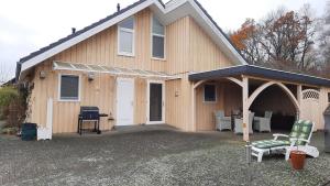 a house with a porch and a grill at Haus am Schaalsee in Zarrentin