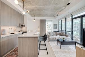a kitchen and living room with a couch and a table at Studio Gem in the lovely Waterfront Communities in Toronto