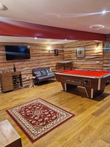 a living room with a pool table and a tv at Cedar Lodge in Bowness-on-Windermere