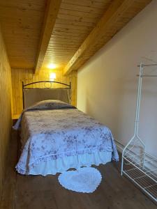 a bedroom with a bed and a wooden ceiling at Il Borghetto in Fiuggi +6 photos
