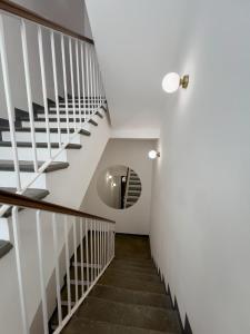 a staircase in a house with a round window at B&B Piazza d'Armi Lamezia Terme - 3 sorrisi in Lamezia Terme