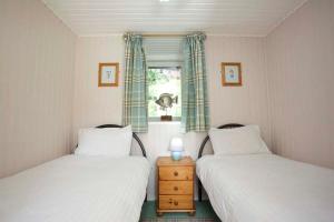 Ένα ή περισσότερα κρεβάτια σε δωμάτιο στο Ivy Tree Cottage