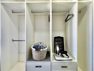 a walk in closet with white cabinets and a basket at Tijuana Condo at Avenida Revolución 9th floor in Tijuana