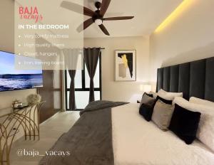 a bedroom with a large bed with a ceiling fan at Rosarito Misión Viejo Sur in La Bloquera