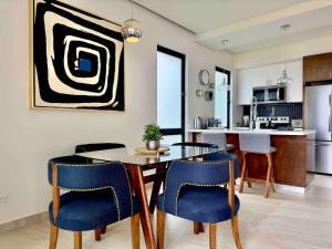 a kitchen and dining room with a table and chairs at Rosarito Misión Viejo Sur in La Bloquera