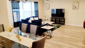 a living room with a dining table and a television at Geaux to Mike The Tiger Retreat Near LSU - CB1021 in Baton Rouge