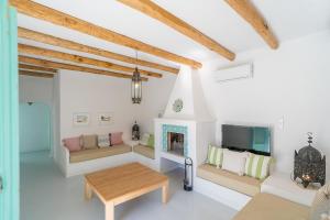 a living room with a couch and a fireplace at Casa de la Tita Belén in La Puebla de los Infantes