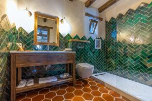 a bathroom with a sink and a toilet and a mirror at Kassandra Heritage in Oludeniz