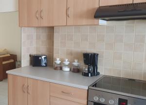 a kitchen with a counter top with a coffee maker at Modern Apartment I & II by Irida Iris Group in Mytilene