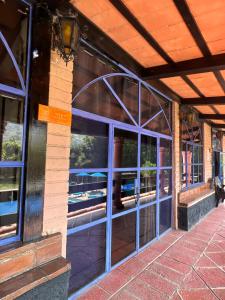 a building with glass windows with a view of a patio at Los Cruxes in Tepoztlán