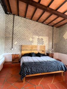 a bedroom with a bed and a bath tub at Los Cruxes in Tepoztlán