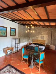 a bedroom with a bed and a table and chairs at Los Cruxes in Tepoztlán
