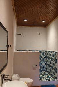 a bathroom with a sink and a toilet at Los Cruxes in Tepoztlán