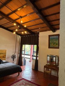 a bedroom with a bed and a ceiling with lights at Los Cruxes in Tepoztlán