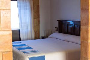 a bedroom with a bed and a window at Hotel Casa Mixteca in Huajuapan de León +12 photos
