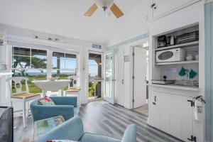 a kitchen and living room with a view of the ocean at Seaside Cottages - Cottage 32A - Seaside Too in South Yarmouth
