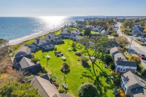 an aerial view of a house with a yard next to the ocean at Seaside Cottages - Cottage 32B - Seaside One and Too in South Yarmouth