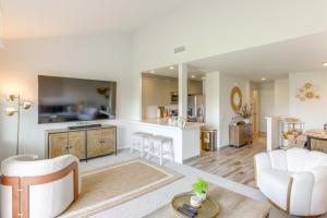 a living room and kitchen with a couch and a table at Steps to Indian Wells Condo with Golf Course Views! in La Quinta